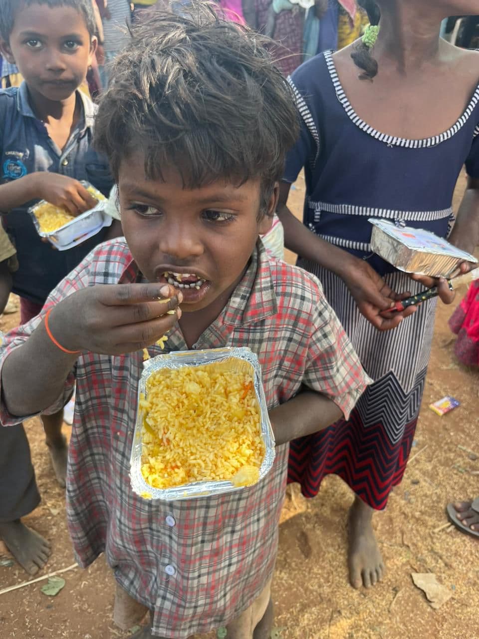 Child eating an MKF Trust Annadanam meal